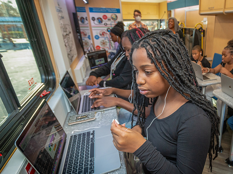 young teens following a STEM based activity led by Howard County Library System teachers within the STEAM machine.