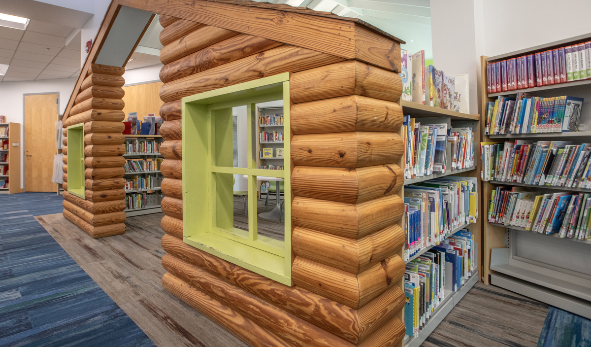 a faux log cabin reading nook for children.