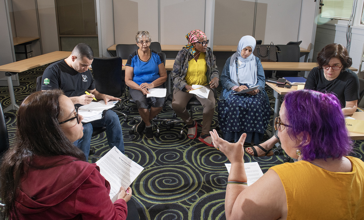 Several Adults practicing language skills.