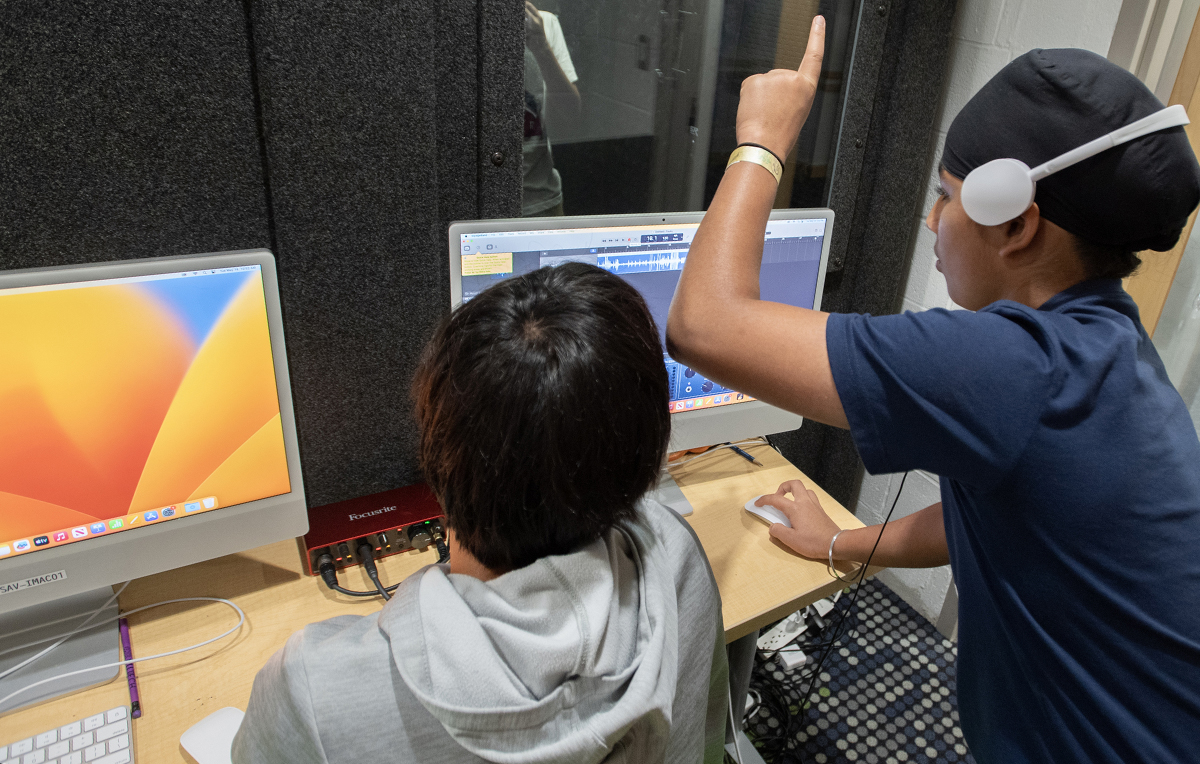 Child recording in sound booth.