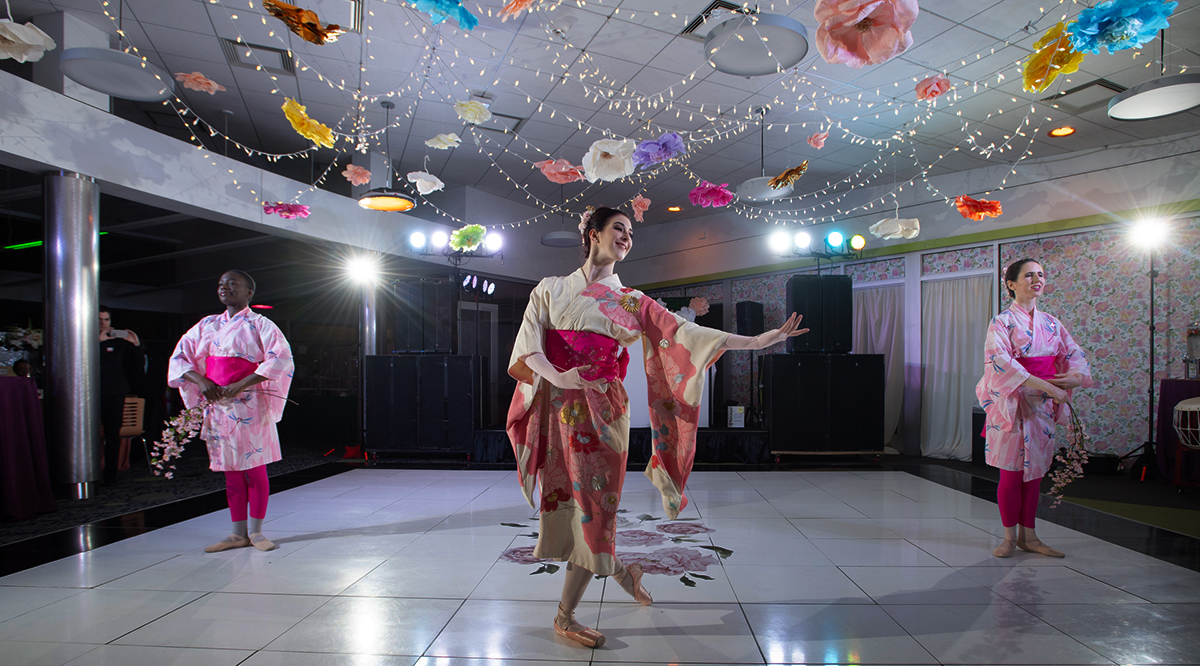 professional dancers with flowers hanging overhead.