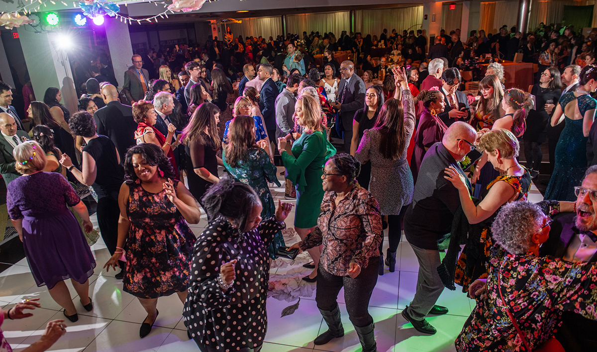 Patrons dancing at evening in the stacks.