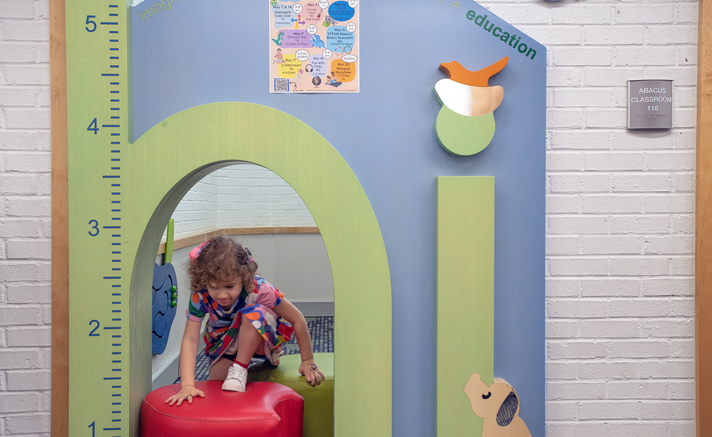 preschooler playing in free play space at library.
