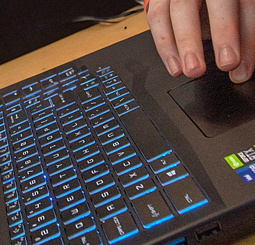 person typing on keyboard.