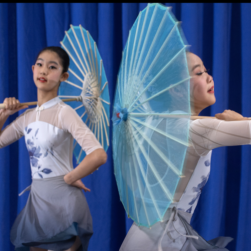 Chinese dancer holding a paper fan.