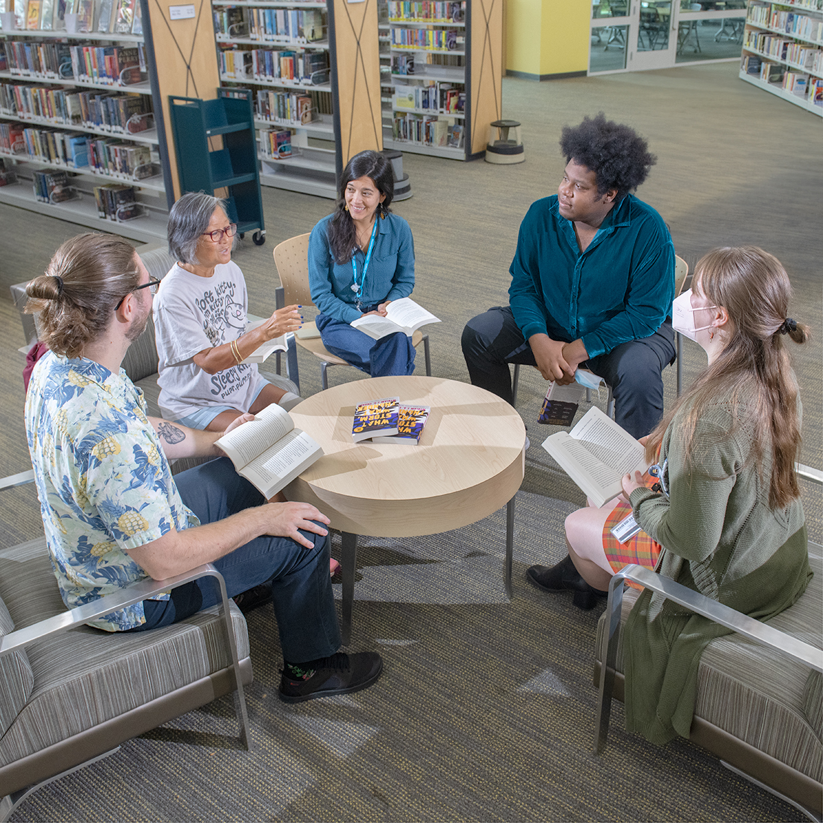 Adults discussing a book.