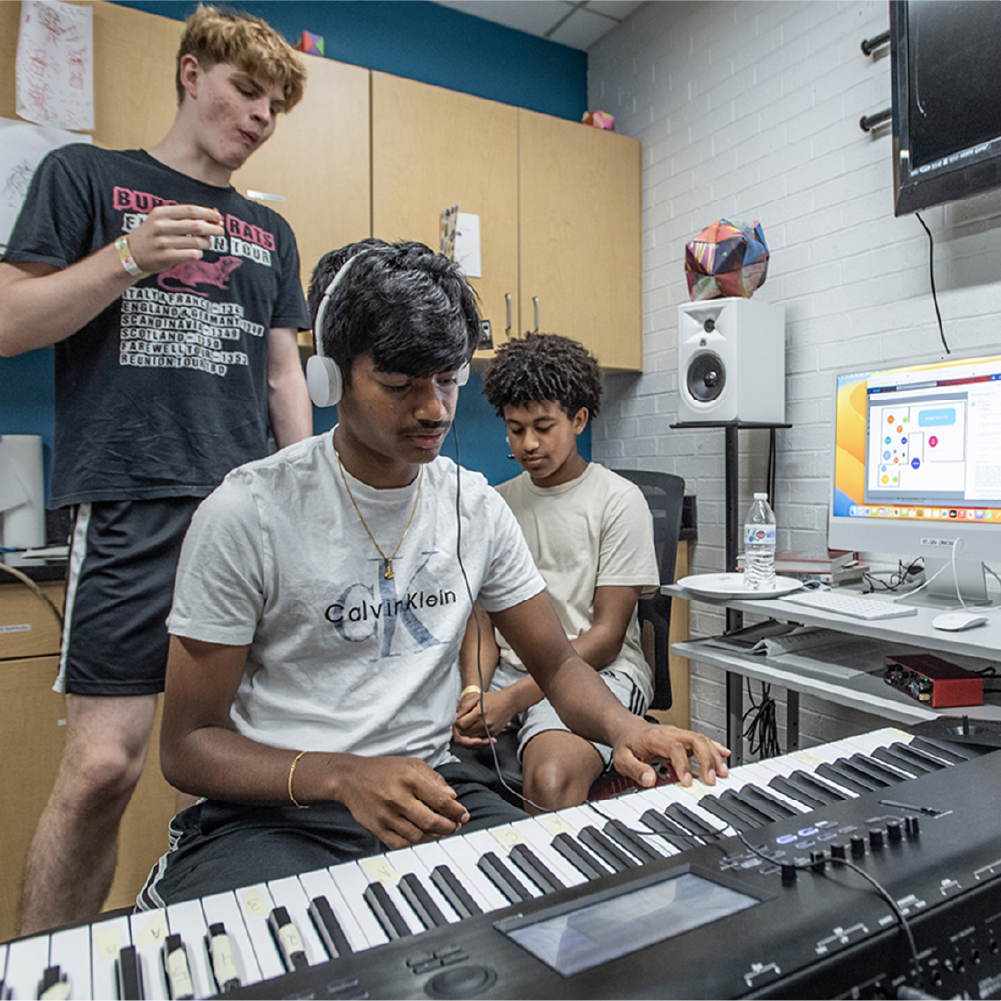 Teenagers recording music on piano.