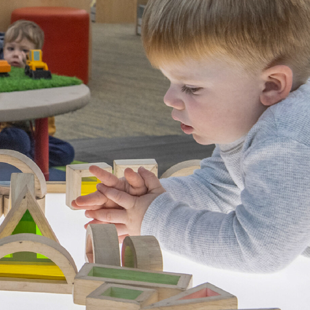 a child playing with blocks at the library