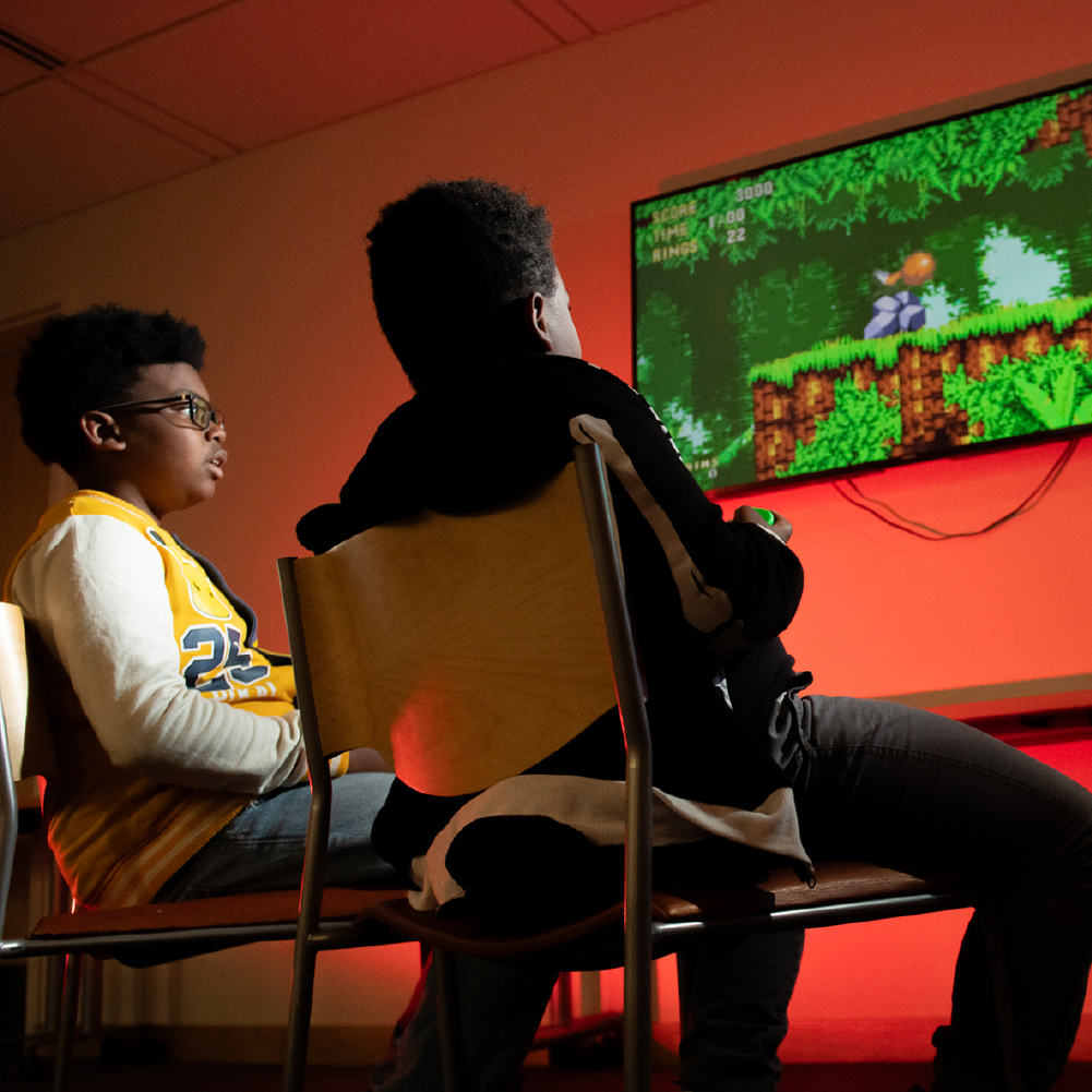 two children playing free video games from the Howard county library video game collection.