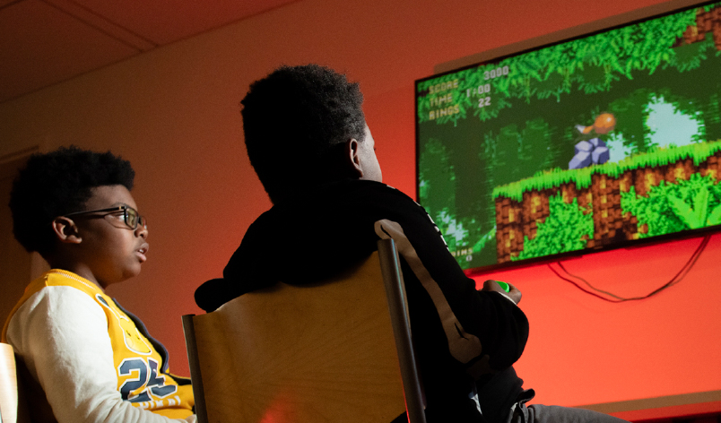 two children playing free video games from the Howard county library video game collection.